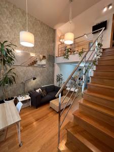 a living room with a staircase in a house at Loft con PARKING "Hygge Urbano Coruña" in A Coruña