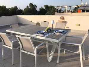 a dining table and chairs on a patio at Villa Smeralda in San Vito lo Capo