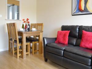 a living room with a couch and a table at Riverside Mews in Bideford