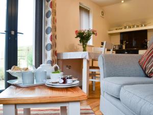 a living room with a table and a couch at The Bothy in Bradworthy