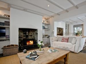 a living room with a couch and a fireplace at Lower Margate Bodmin in Bodmin