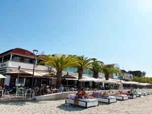 a group of people sitting on lounge chairs on the beach at Apartamentos Turísticos Magallanes I in San Pedro del Pinatar