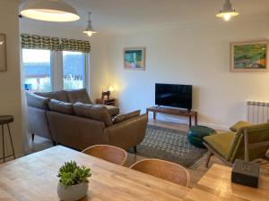 a living room with a couch and a table at The Haven in Beadnell