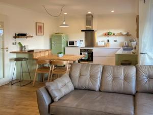 a living room with a couch and a kitchen at The Haven in Beadnell