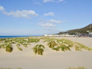 a sandy beach with condos in the background at Barreg in Barmouth