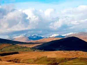 a view of a mountain range with snow covered mountains at Foldgate in Waberthwaite