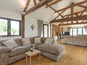 a living room with a couch and a table at Summer House Stables in Catfield