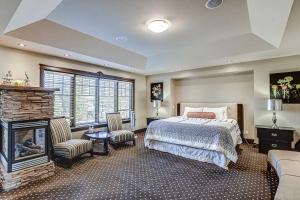 a bedroom with a bed and a fireplace at Westmount River Inn in Calgary