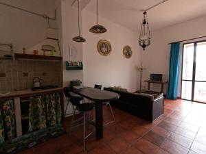 a kitchen with a table and a couch in a room at Casale Galati in Sciacca