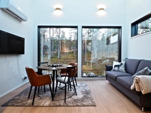 a living room with a couch and a table and chairs at Levillas Levin Tuulahdus in Sirkka