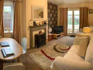 a living room with a couch and a table at Oak Lodge in Longham