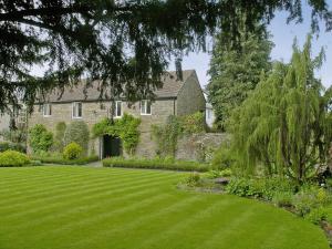 a large lawn in front of a house at The Coach House in Kington