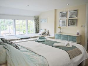 a bedroom with two beds and a window at Abacus in Two Dales