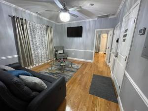 a living room with a couch and a tv at Brand New Luxury Rooms near downtown Boston in Boston