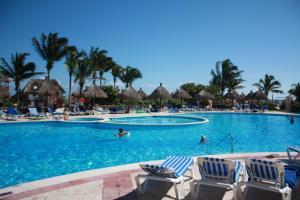 a pool at a resort with people swimming in it at TAO Modern Retreat in Akumal