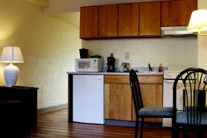 a kitchen with a white refrigerator and a microwave at The Driftwood Lodge in Juneau