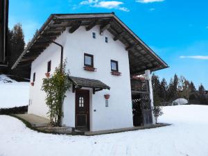 a small white house in the snow at Attractive chalet in Transacqua with garden in Transacqua