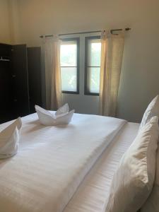Postel nebo postele na pokoji v ubytování บ้านธานี (BAAN THANI)
