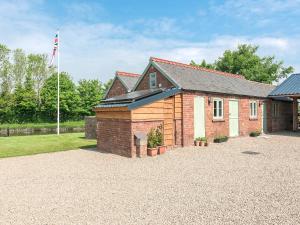 a brick house with a flag on top of it at Canal View in Ellesmere