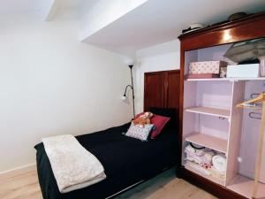 um pequeno quarto com uma cama e uma prateleira em COSY Home - 2 à 4 pers - Aéroport - vieux Blagnac em Blagnac