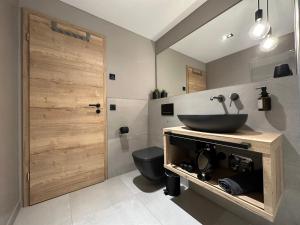 a bathroom with a sink and a toilet at Apartment34 in Öhringen