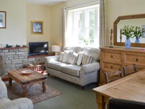 a living room with a couch and a tv at Cheviot View in Alnwick