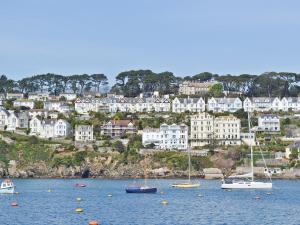 a group of boats in the water in front of a city at Waterside in Fowey