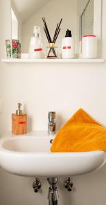 um lavatório de casa de banho com um espelho e uma toalha em Gasthuis 20 verdiep 2 em Kuurne