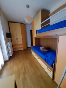 a bedroom with a bunk bed with blue sheets at Milano Linate Airport Apartment in Peschiera Borromeo