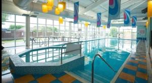 a large swimming pool in a building at Hazel grove - Withernsea Sands in Waxholme