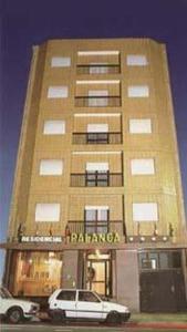 a building with two cars parked in front of it at Hotel Palanca in Porto