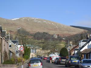 a street in a small town with a mountain at The Bothy in Glendevon