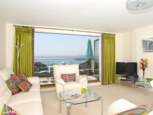 a living room with a view of the ocean at Tree Tops - A4 Masts in Torquay