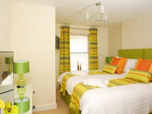 a bedroom with two beds and a window at Tree Tops - A4 Masts in Torquay