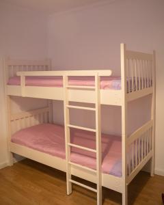 a pair of bunk beds in a room at City Block Apartment in Pristina