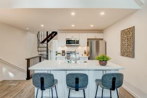 a kitchen with a white counter and three stools at Crystal Bay Comfort in Incline Village