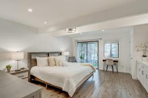 a white bedroom with a large bed and a desk at Crystal Bay Comfort in Incline Village