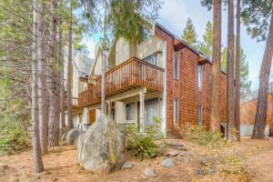 a house in the woods with a large rock in front of it at Crystal Bay Comfort in Incline Village