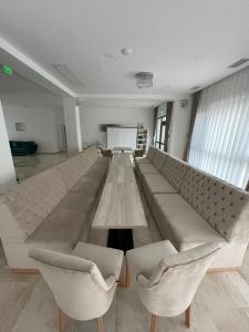 a large couch in a room with two chairs at Majestic Boutique Hotel in Baile Felix