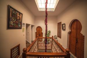a hallway with a spiral staircase with wooden doors at Riad Dari in Tetouan