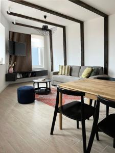 a living room with a table and a couch at Randevu Nivalis in Jahorina