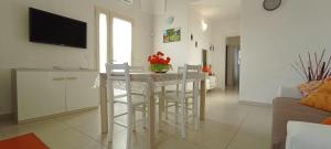 a kitchen and living room with a table and chairs at La Casetta 22 in Andrano