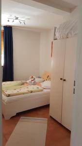 a bedroom with a bed and a white cabinet at Villa Behija Ferienwohnung 3 Crikvenica in Crikvenica