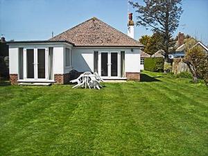 a house with a white sculpture in the yard at The Glade in Ferring