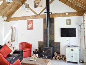 a living room with a wood stove at The Parlour in Arlingham