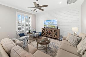 a living room with a couch and a tv at Starfish Cottage in Gulf Shores
