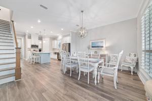 a dining room and kitchen with a table and chairs at Starfish Cottage in Gulf Shores
