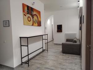 a living room with a couch and a painting on the wall at Airport Boulevard Guesthouse in Grassobbio