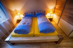 a bedroom with a yellow bed with two pillows at Residence Bellevue in Zermatt