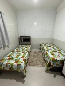 Ліжко або ліжка в номері Casa Bairro Boa Vista 1